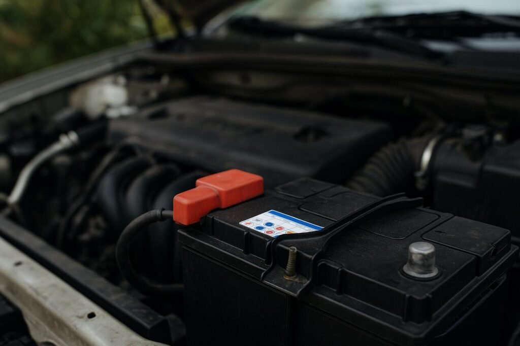 Close-up of a car battery under the hood of a vehicle.
