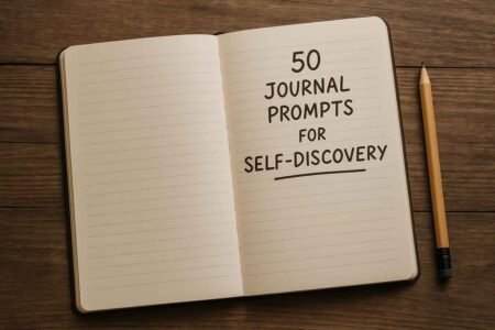 Open journal and pencil on wooden desk for self-discovery journaling.