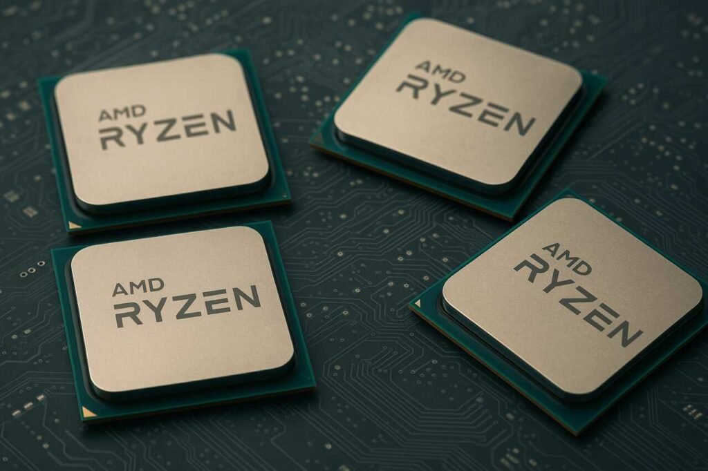 Four AMD Ryzen AM4 CPUs placed on a circuit board background.